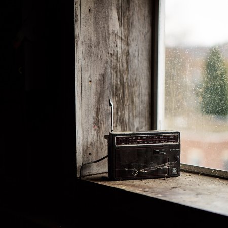 image of old-fashioned radio on a wood window sill